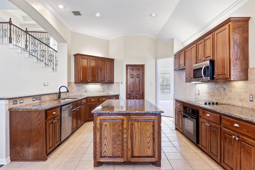 2021 Country Brook Lane Allen, TX 75002 - Photo 15 of 40 a kitchen with stainless steel appliances granite countertop a sink and a stove