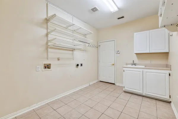 a view of a kitchen with white cabinets