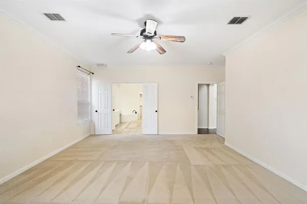 a view of a room with a ceiling fan