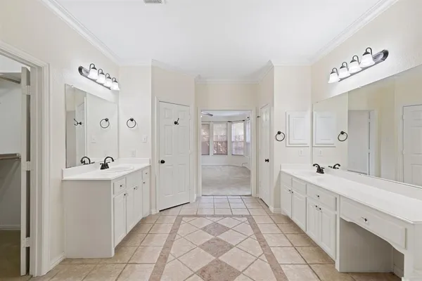 a spacious bathroom with a double vanity sink mirror and a bathtub