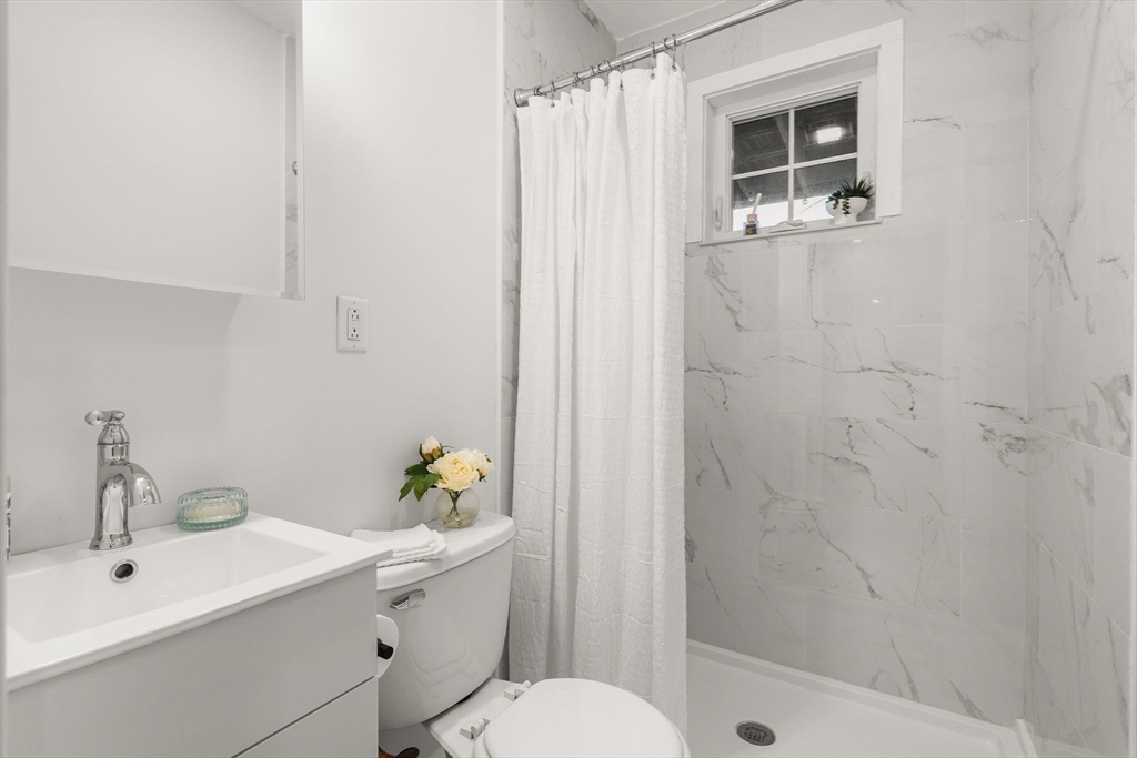 3 Spring Garden Street, Unit 1 Boston, MA 02125 - Photo 12 of 23 a bathroom with a sink toilet and shower