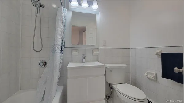 a white toilet sitting next to a bathroom sink
