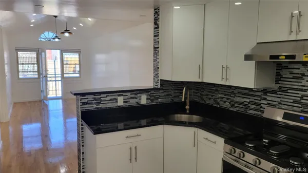 a kitchen with a sink and a stove top oven