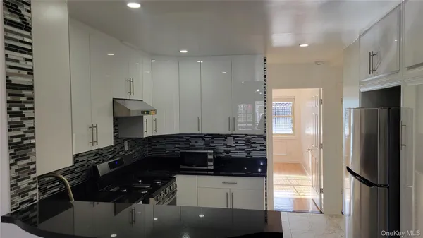 a kitchen with a refrigerator and a sink