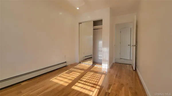 a view of an empty room and wooden floor