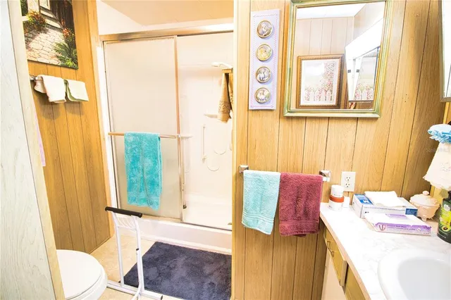 a bedroom with a bed and a window with chair