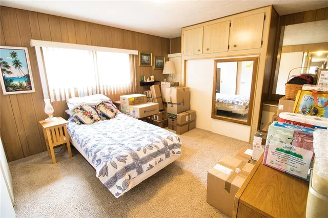 a bedroom with a bed couch and a window