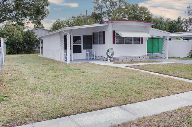 a view of a yard with a house and wooden fence