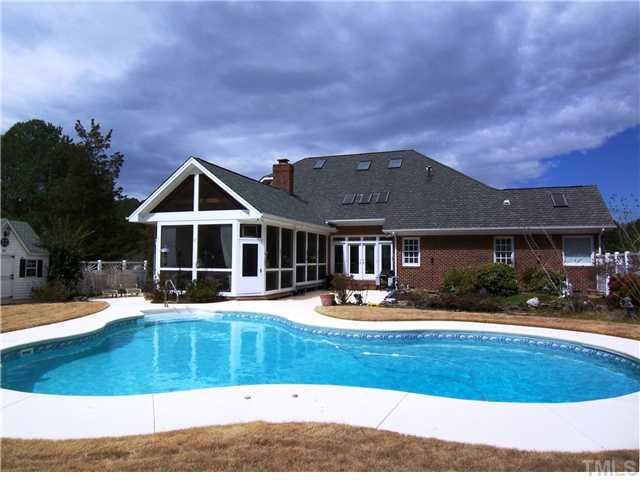 908 Rockfall Court Raleigh, NC 27614 - Photo 22 of 25 To-die-for landscaped backyard features a 35,000 gal salt water pool w/automatic pool cleaner, filtered 3,500 gal koi pond w/2 waterfalls, huge Patio, smaller side Patio, Storage Shed, NEW state of the art Septic System & gorgeous Screened Porch! Exterior Back