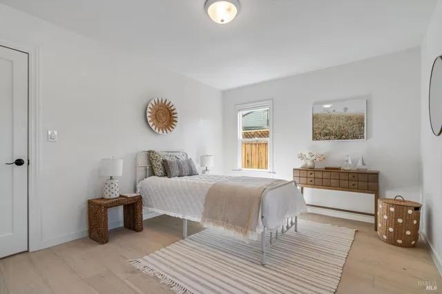 a bedroom with furniture and a window