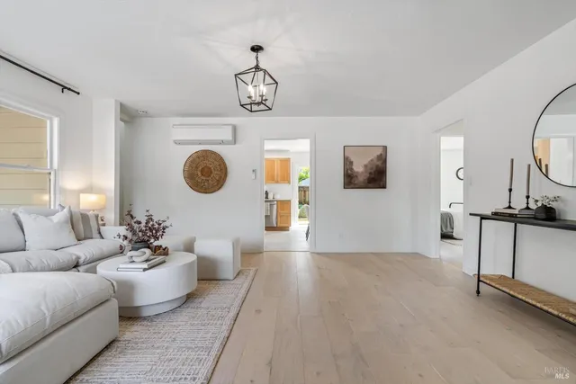 a living room with furniture a rug and a large window