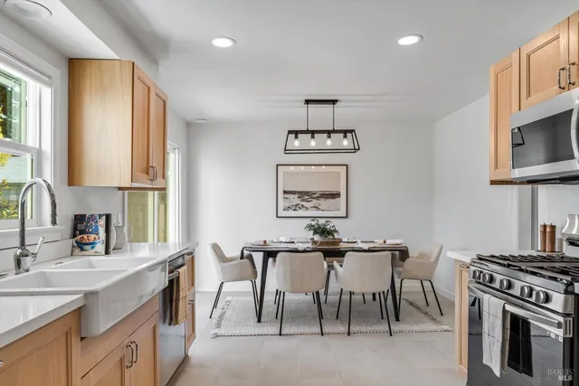 a kitchen with stainless steel appliances a sink stove and cabinets