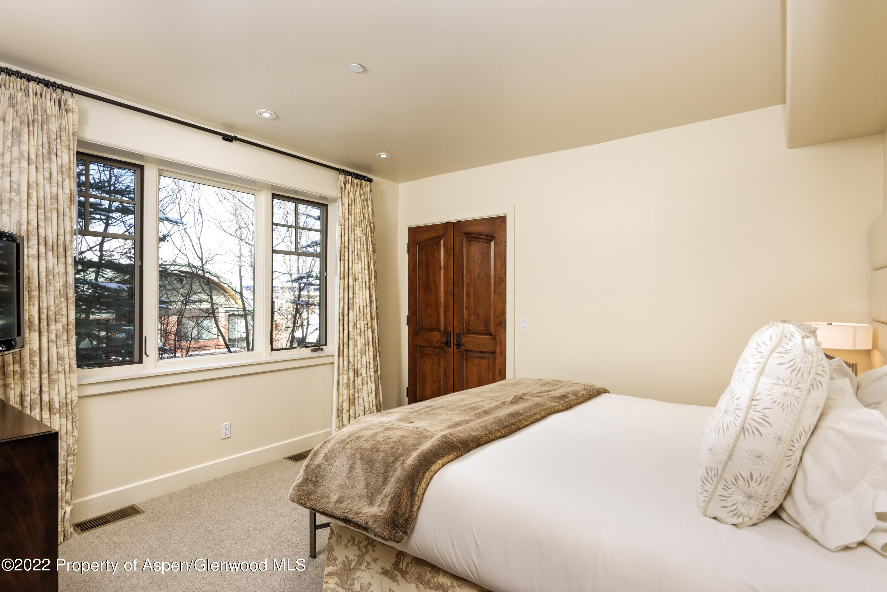 704 South Galena Street Aspen, CO 81611 - Photo 11 of 18 a bedroom with a bed and a large window