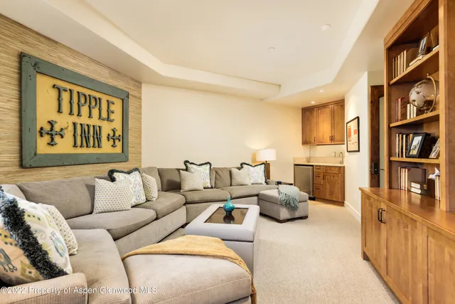 a living room with furniture fireplace and baby crib
