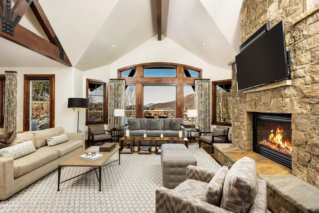 a living room with furniture fireplace and flat screen tv