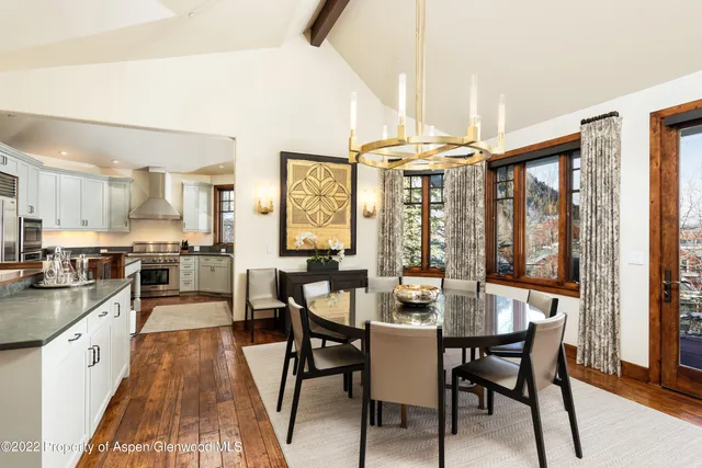 a large kitchen with a table and chairs