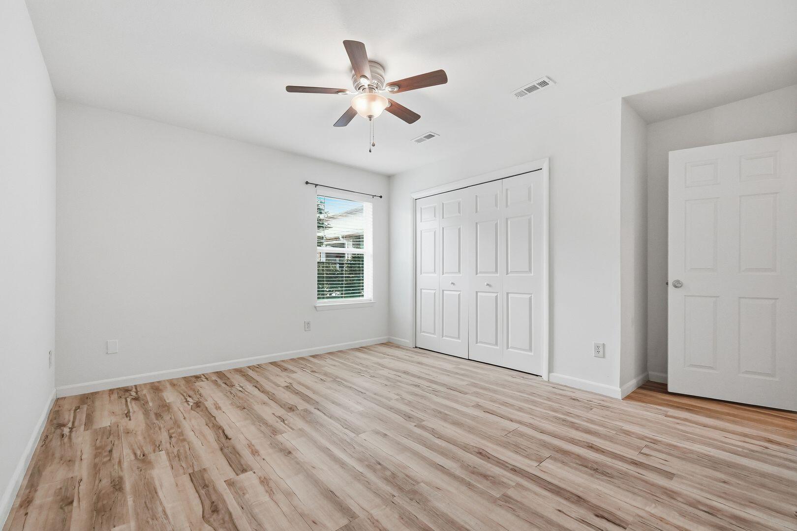 5 Kelly Way Valparaiso, FL 32580 - Photo 23 of 31 an empty room with wooden floor fan and windows