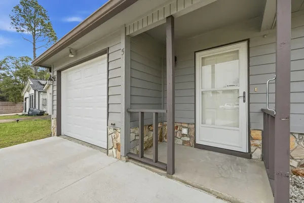 a view of a porch with a door and a yard