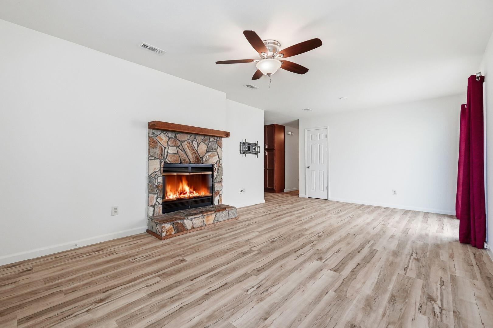 5 Kelly Way Valparaiso, FL 32580 - Photo 4 of 30 a view of an empty room with wooden floor fireplace and a window