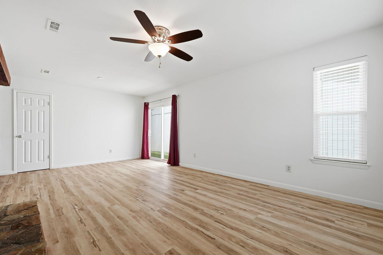 5 Kelly Way Valparaiso, FL 32580 - Photo 5 of 30 a view of an empty room with wooden floor and a window