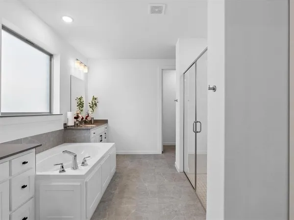 a bathroom with a bathtub and shower