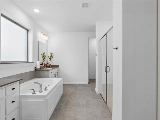 a bathroom with a bathtub and shower