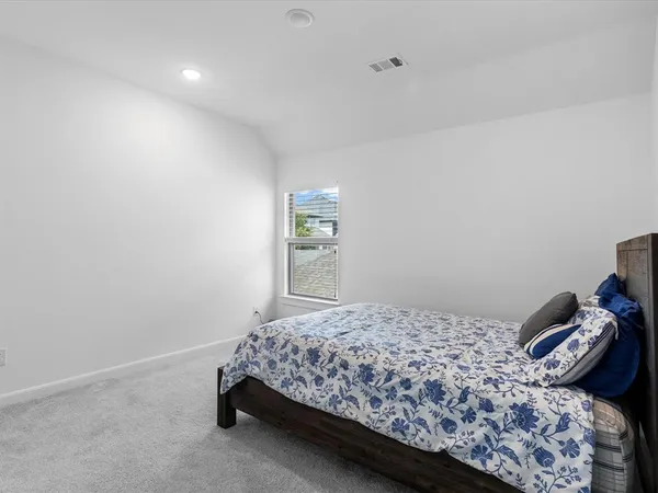 a bedroom with a bed and window