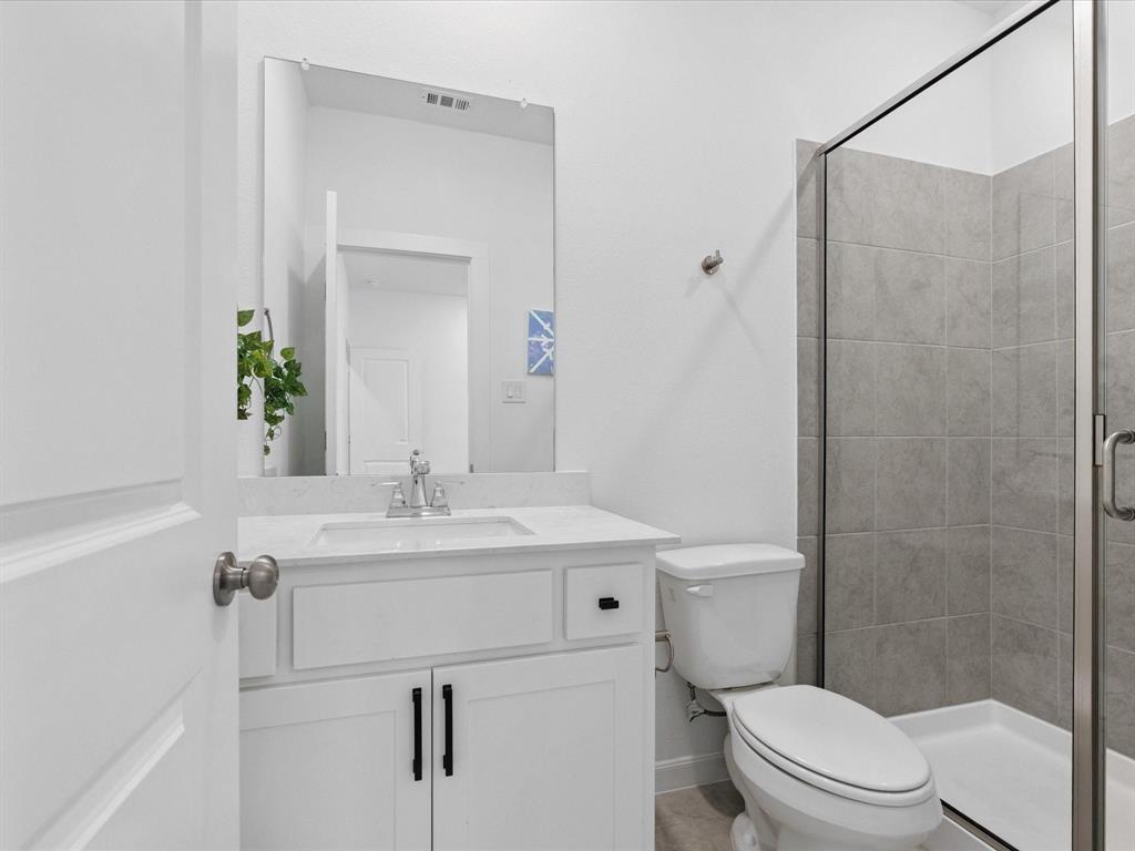 4828 Celestial Road McKinney, TX 75071 - Photo 16 of 25 a bathroom with a sink a toilet and shower