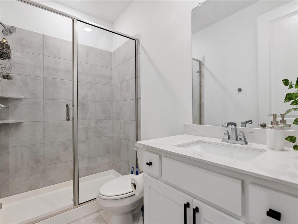 4828 Celestial Road McKinney, TX 75071 - Photo 22 of 25 a bathroom with a sink toilet and shower