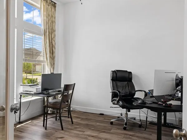a view of a workspace with furniture and a window