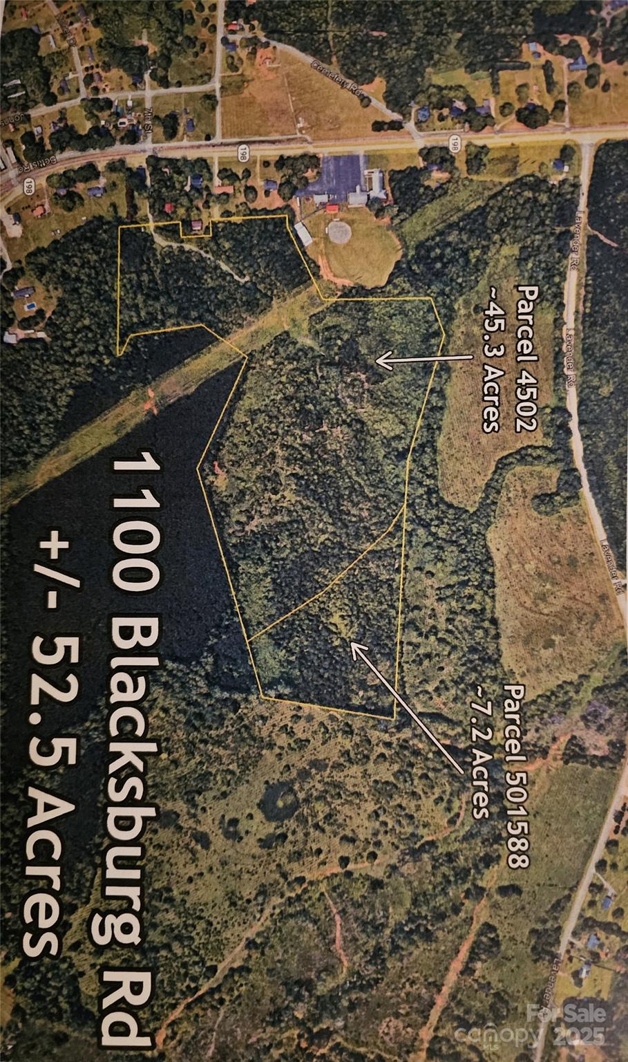 an aerial view of residential houses with yard