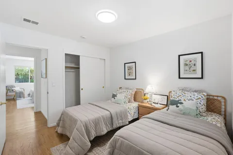 a bedroom with two beds and a table