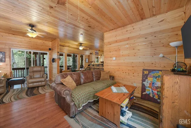 a dining area with furniture a kitchen view and a large window