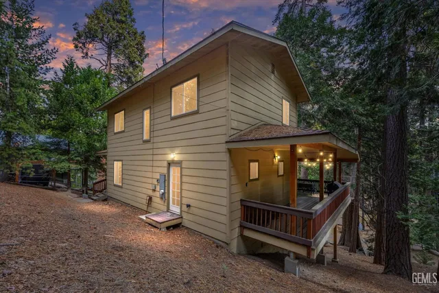 a view of a house with a yard and wooden fence