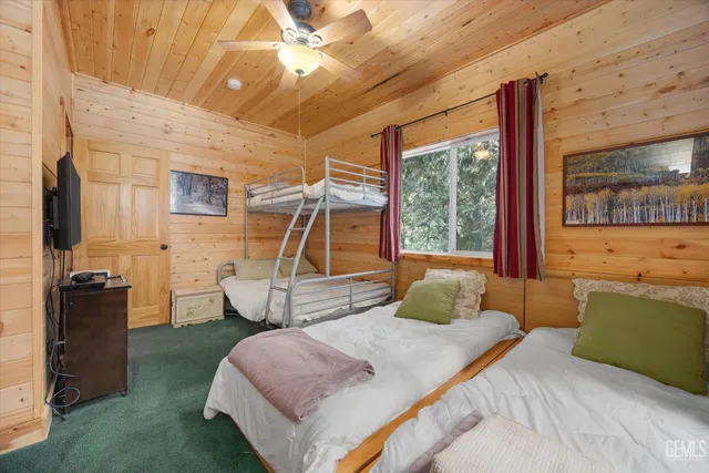 a bedroom with a bed window and couch