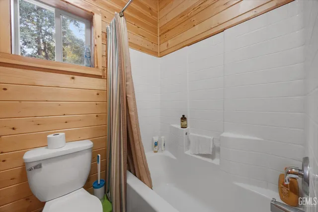a bedroom with bed and a chandelier
