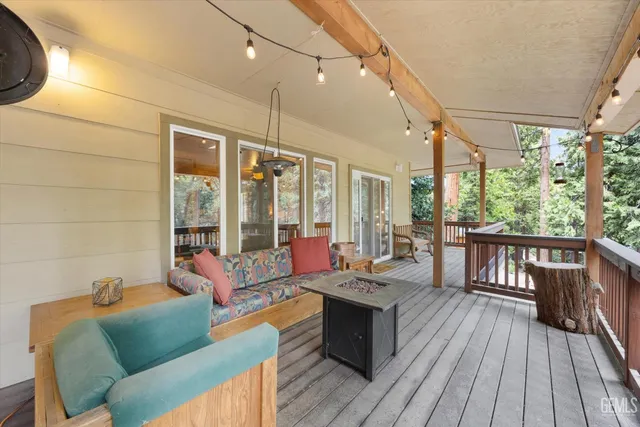 a view of a balcony with chairs and wooden floor