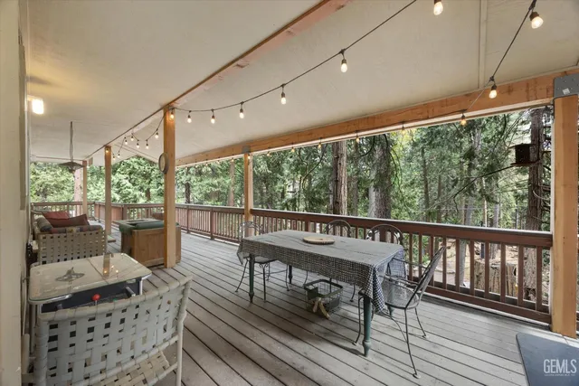 a view of a dining room with furniture a kitchen and chandelier