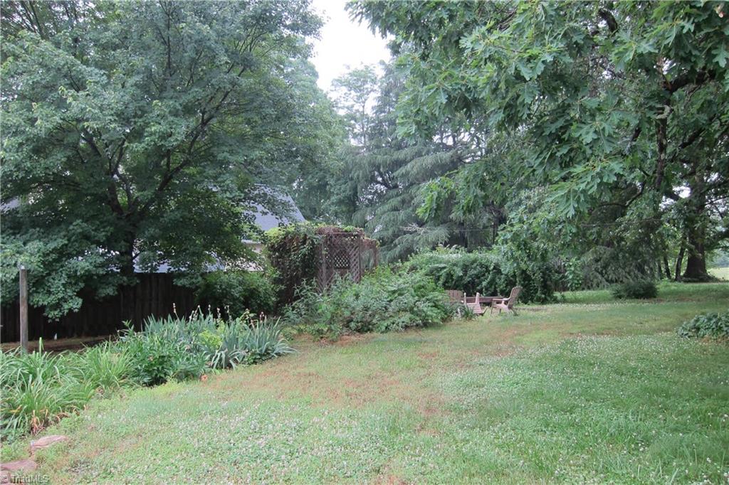 2419 Oak Ridge Road Oak Ridge, NC 27310 - Photo 23 of 30 Great backyard with mature trees and vegetation.