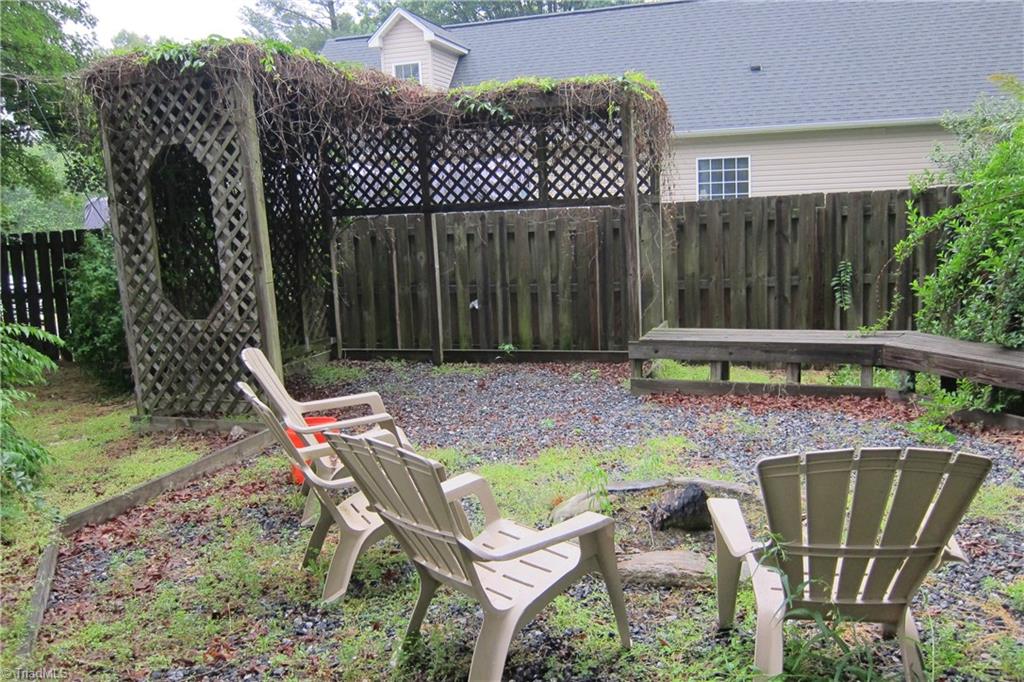 2419 Oak Ridge Road Oak Ridge, NC 27310 - Photo 24 of 30 Fire pit area with built-in seating.
