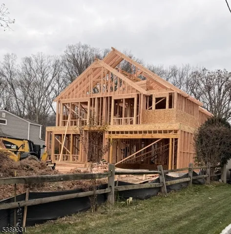 a view of house with swimming pool and outdoor seating