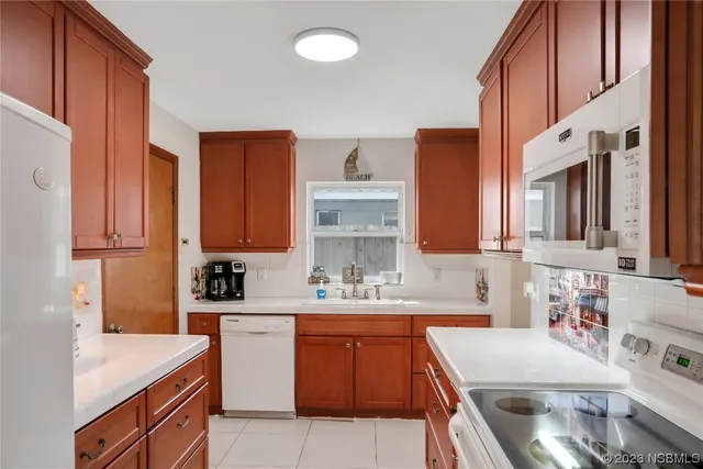 a kitchen with stainless steel appliances granite countertop a sink and a microwave oven