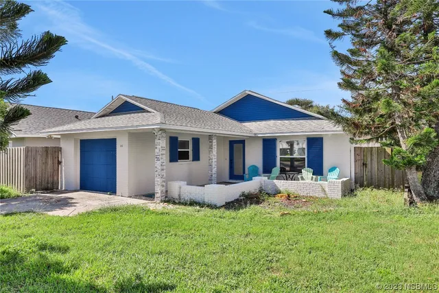 a view of a house with backyard sitting area and garden