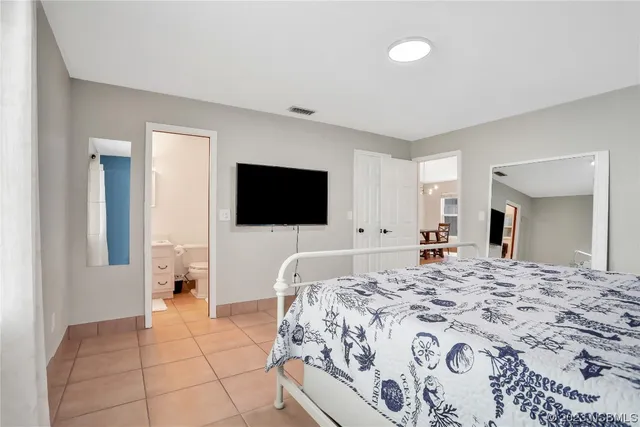 a bedroom with a bed and table