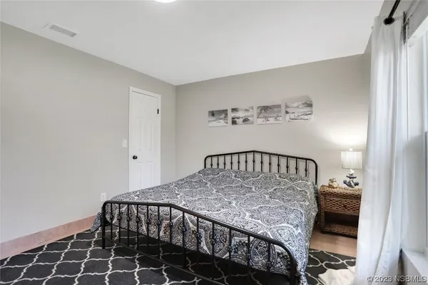 a bedroom with two beds and a window