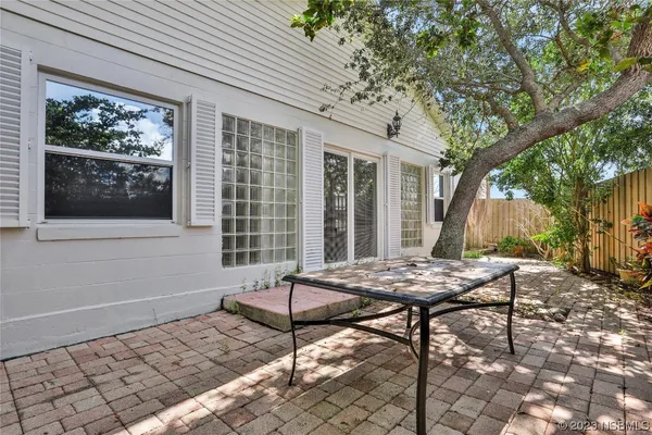a front view of a house with a garden and trees