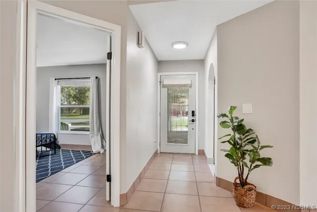 a view of a dining room and livingroom with furniture wooden floor a chandelier