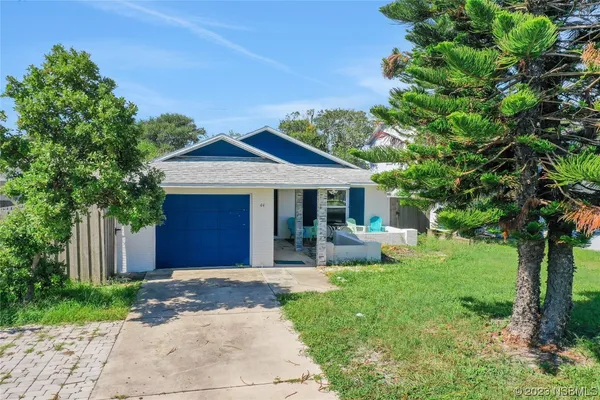 an aerial view of a houses with a yard