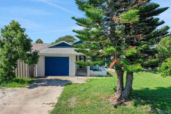 an aerial view of a houses with a yard
