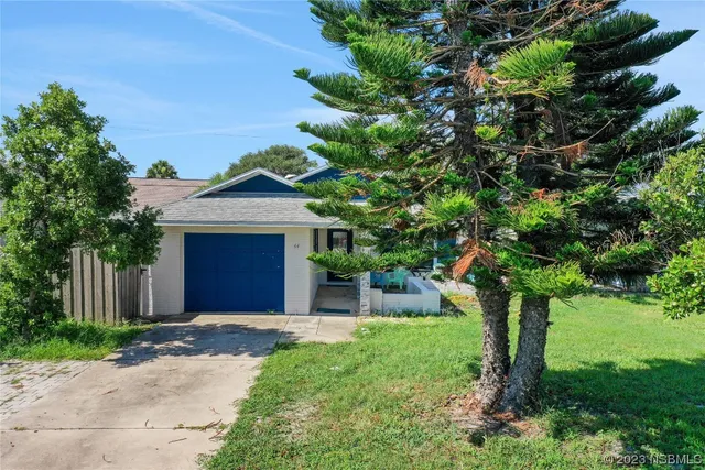 an aerial view of a houses with a yard